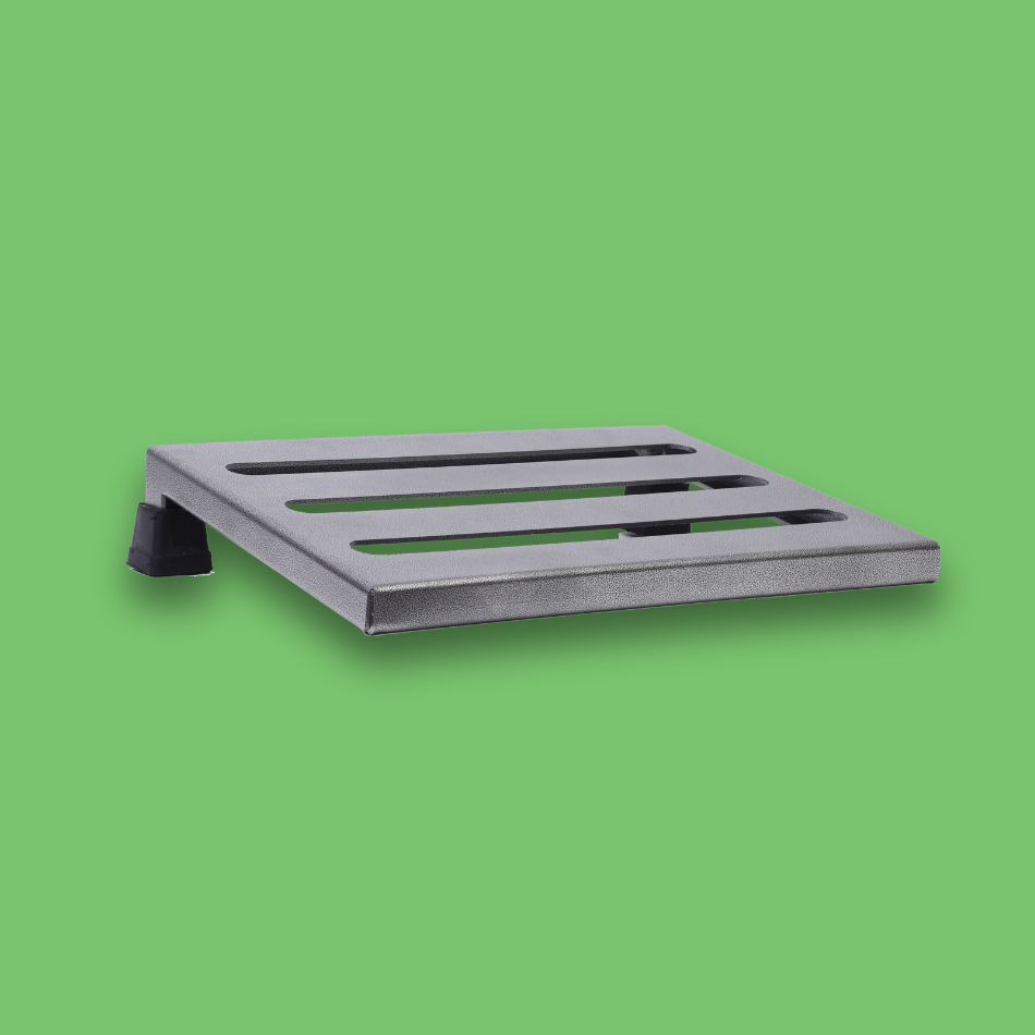 An angled view of an incline grey guitar effects pedalboard made of single sheet of aluminium with 2 legs and rubber bushings.