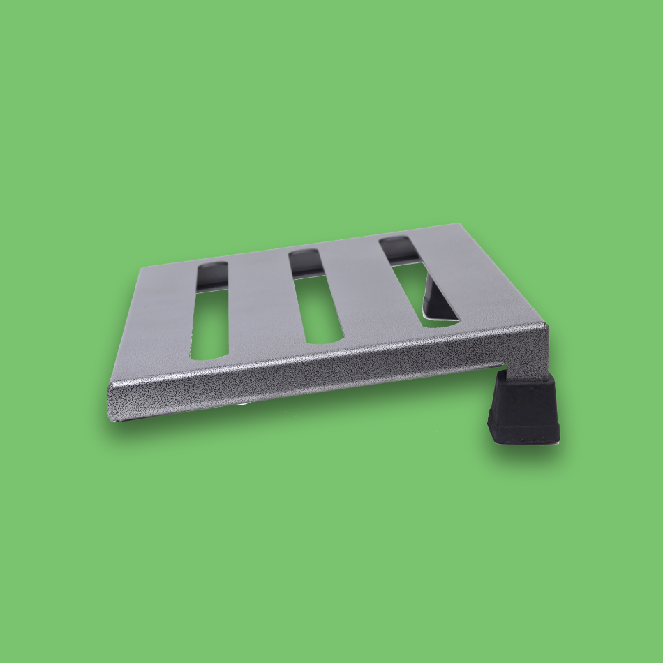 A side view of an incline grey guitar effects pedalboard made of single sheet of aluminium with 2 legs and rubber bushings.