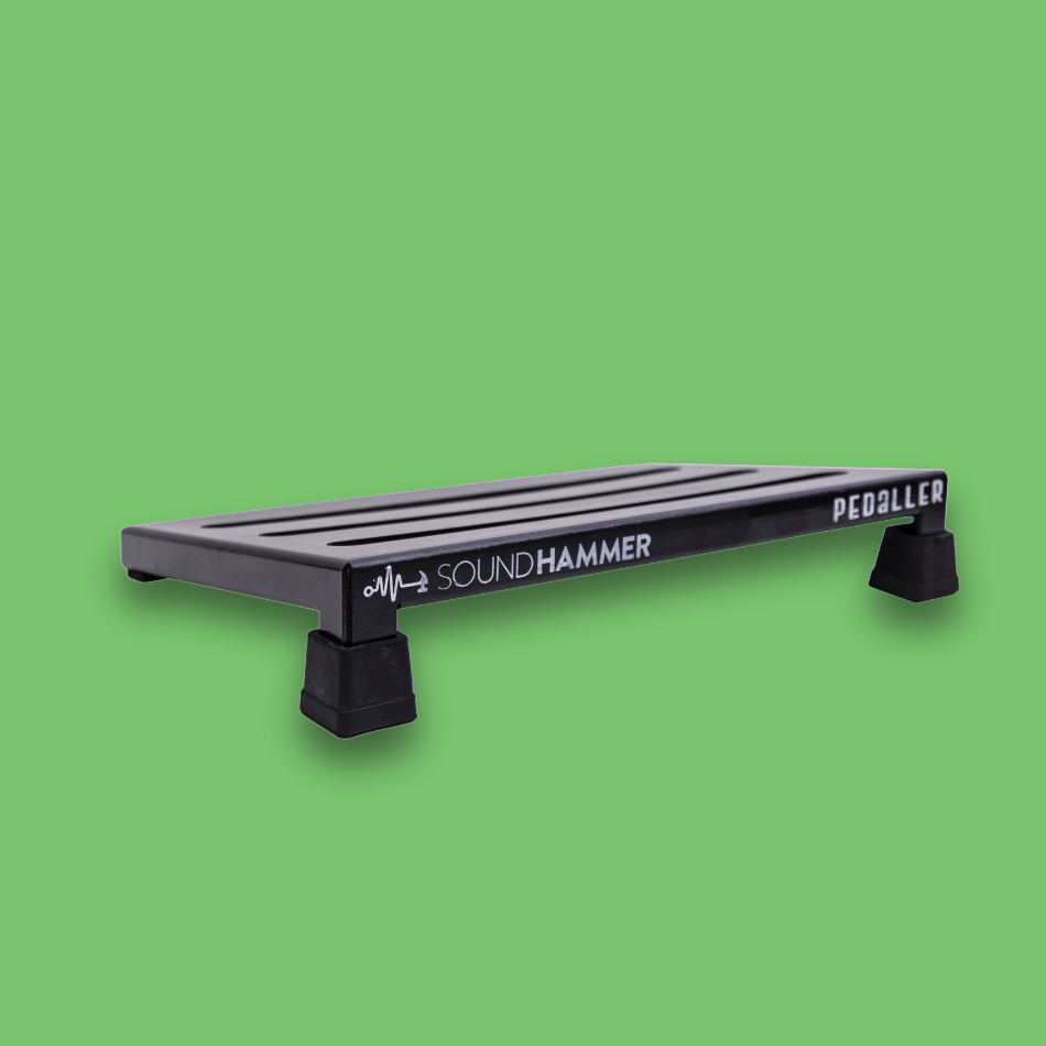A top angled view of an incline black guitar effects pedalboard made of single sheet of aluminium with 2 legs and rubber bushings with Soundhammer logo.