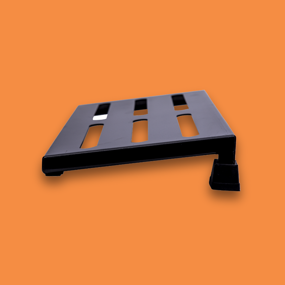 A side view of a medium incline black guitar effects pedalboard made of single sheet of aluminium with 2 legs and rubber bushings.