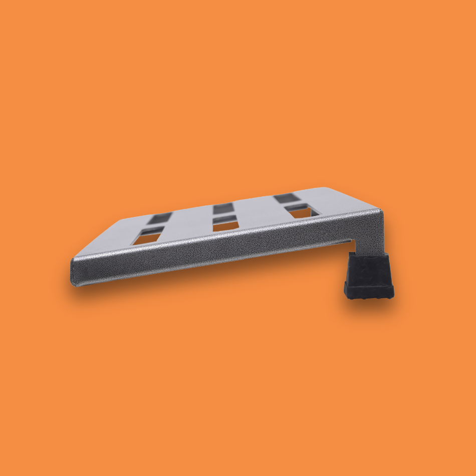 A side view of a medium incline grey guitar effects pedalboard made of single sheet of aluminium with 2 legs and rubber bushings.