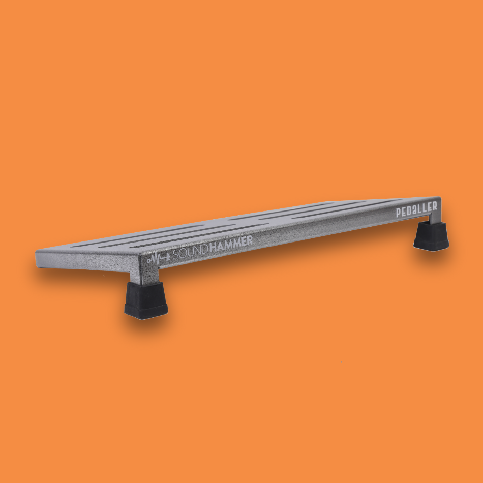A top angled view of a medium incline grey guitar effects pedalboard made of single sheet of aluminium with 2 legs and rubber bushings with Soundhammer logo.