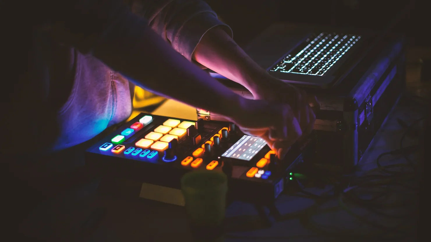 musician's hand on a edm console