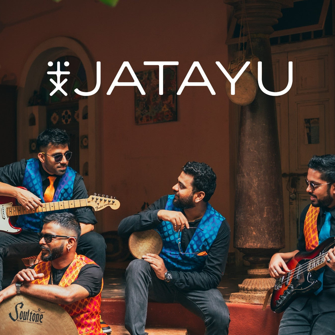 four members of jatayu band sitting with electric guitars in hand