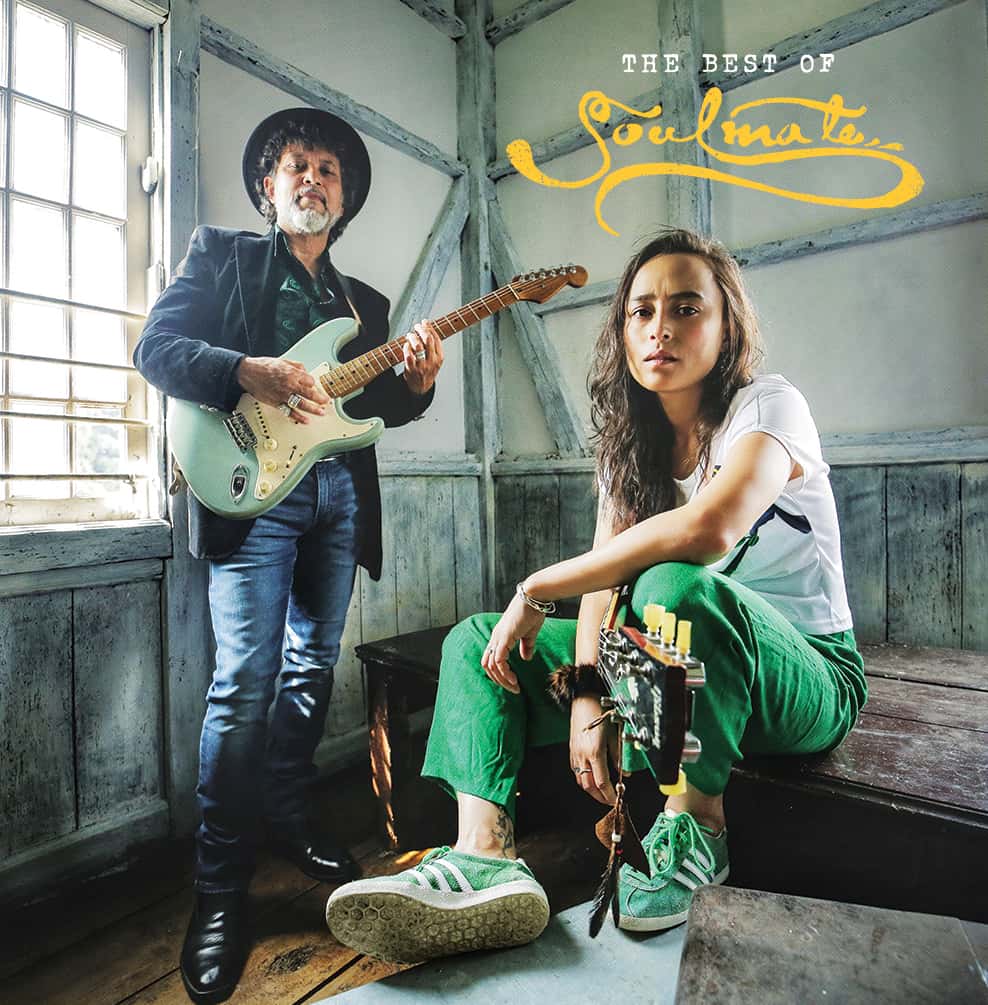 members of soulmate band posing with surf green electric guitar