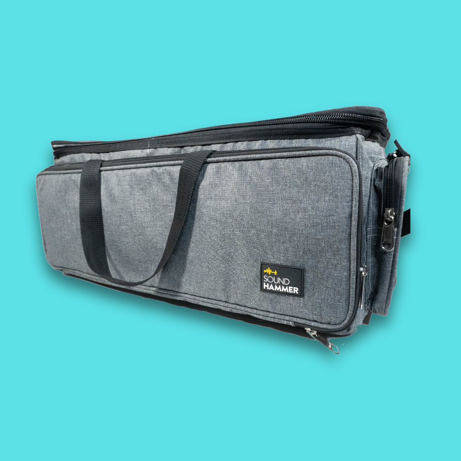 An angled front view of large cable bag in grey color with pouches and straps