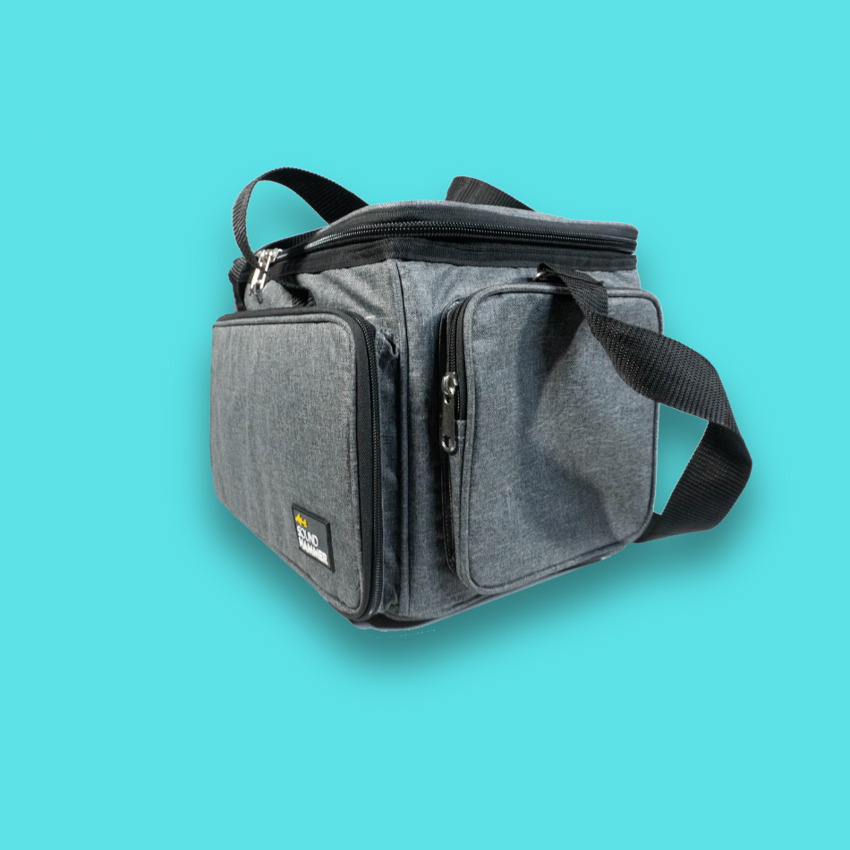 A angled side view of small cable bag in grey color with pouches and straps