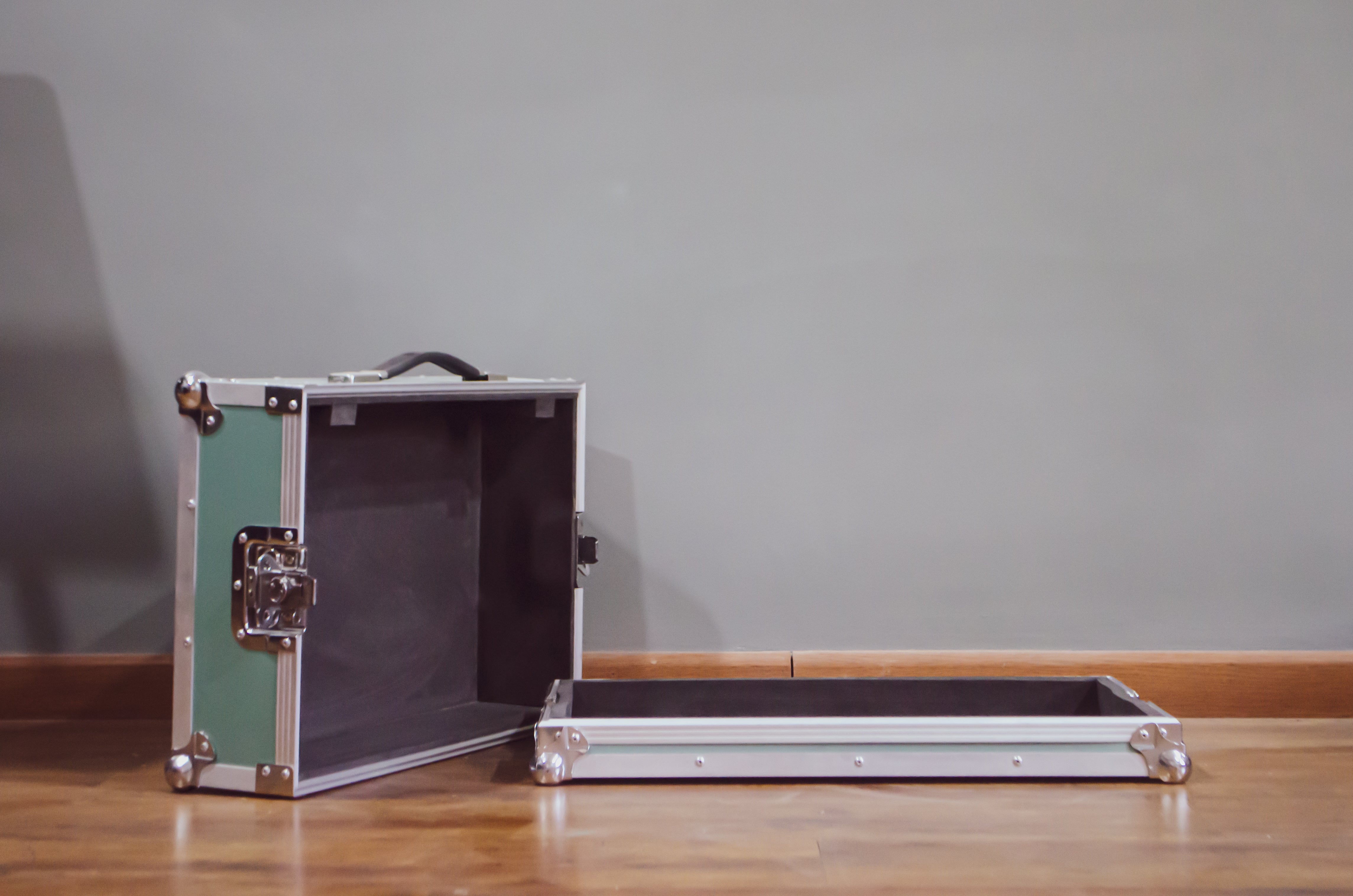 front view of an open custom guitar pedalboard flight case in surf green color