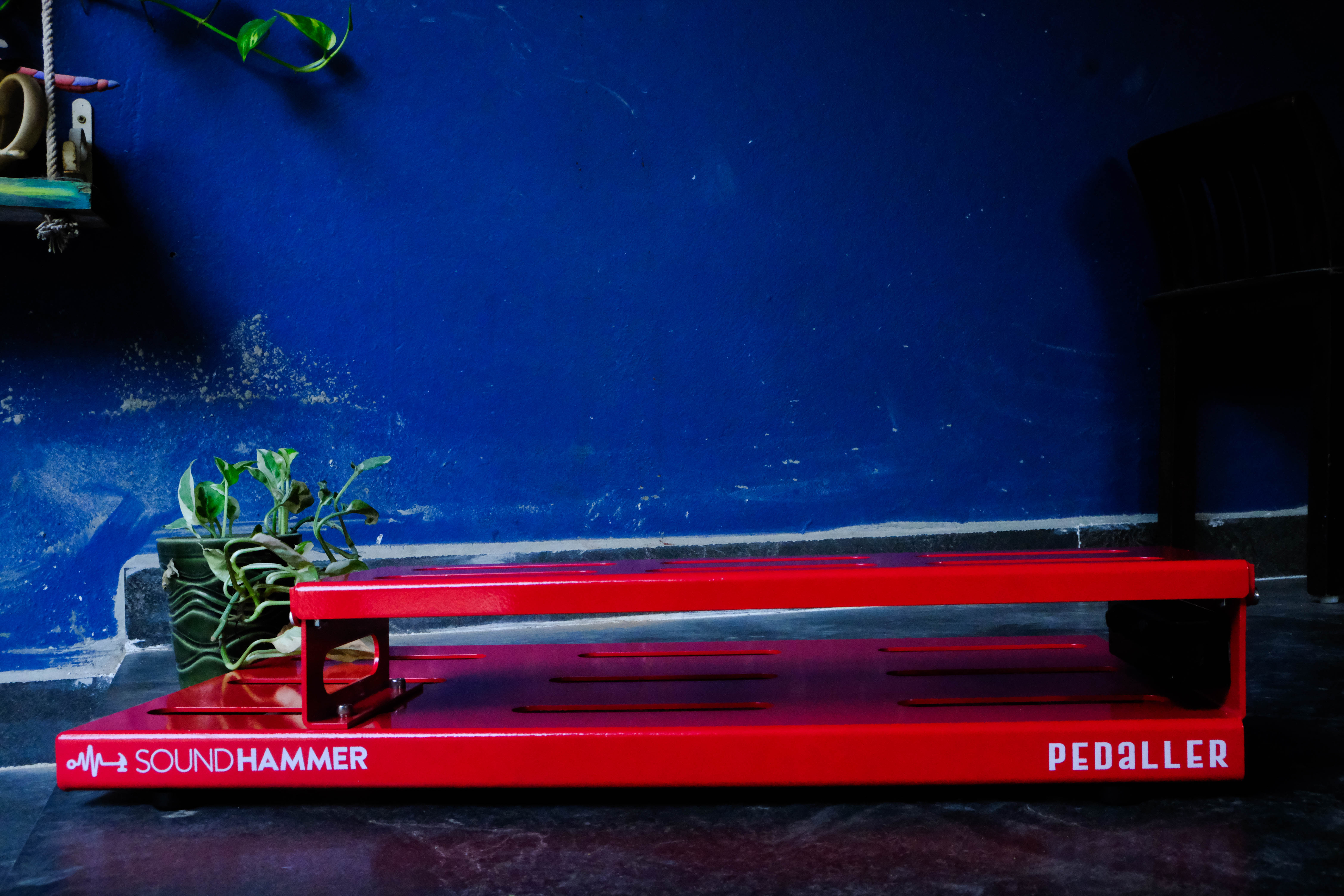 back view of red color double decker guitar pedalboard