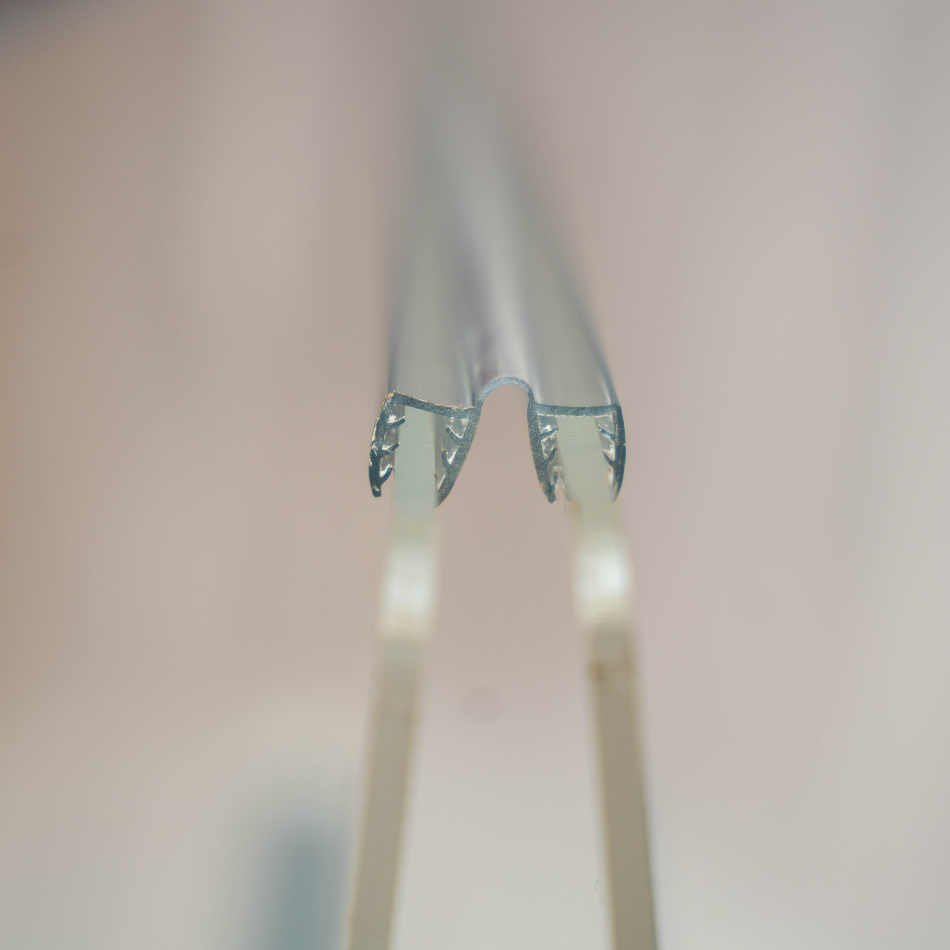 A close up view of acrylic sound seal hinge placed onto the acrylic sheet of drum shield for complete sound seal.