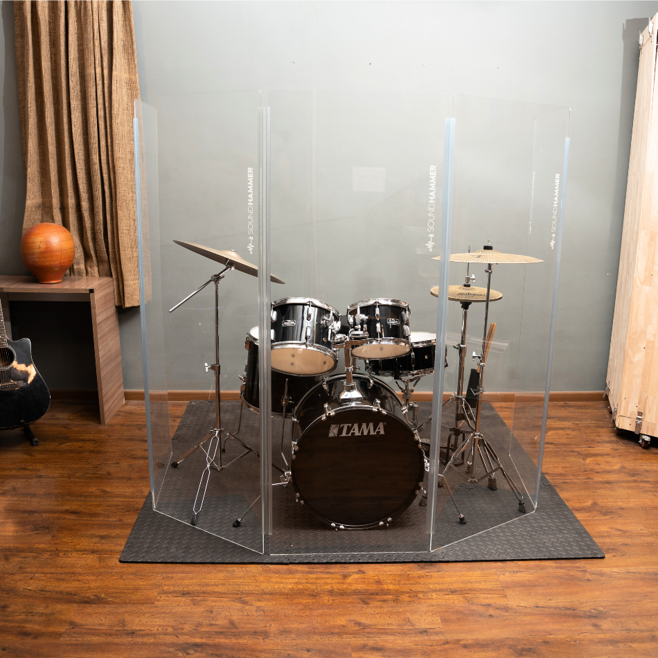 A front top view of drum shield made of acrylic sheet with no bleed sound seal hinges of soundhammer in front of Tama drum kit.