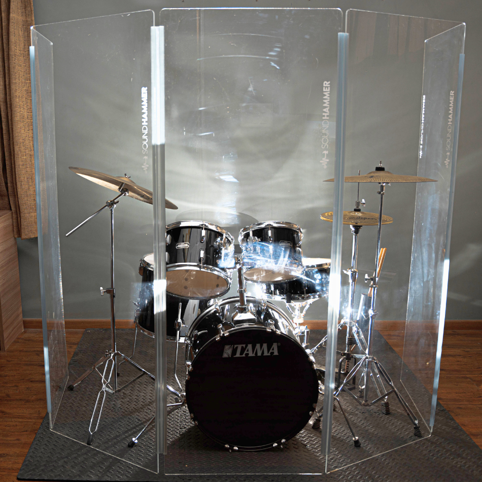 A front view of drum shield made of acrylic sheet with no bleed sound seal hinges of soundhammer in front of Tama drum kit.