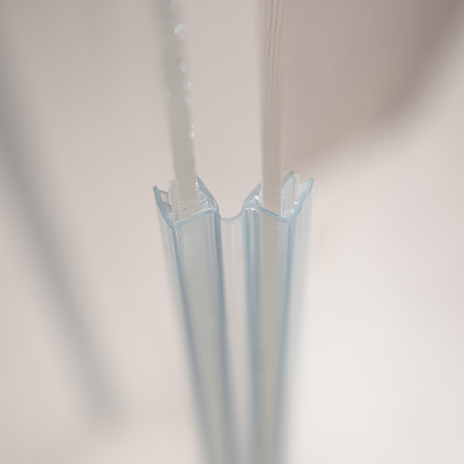 A close up side view of acrylic sound seal hinge placed onto the acrylic sheet of drum shield for complete sound seal.