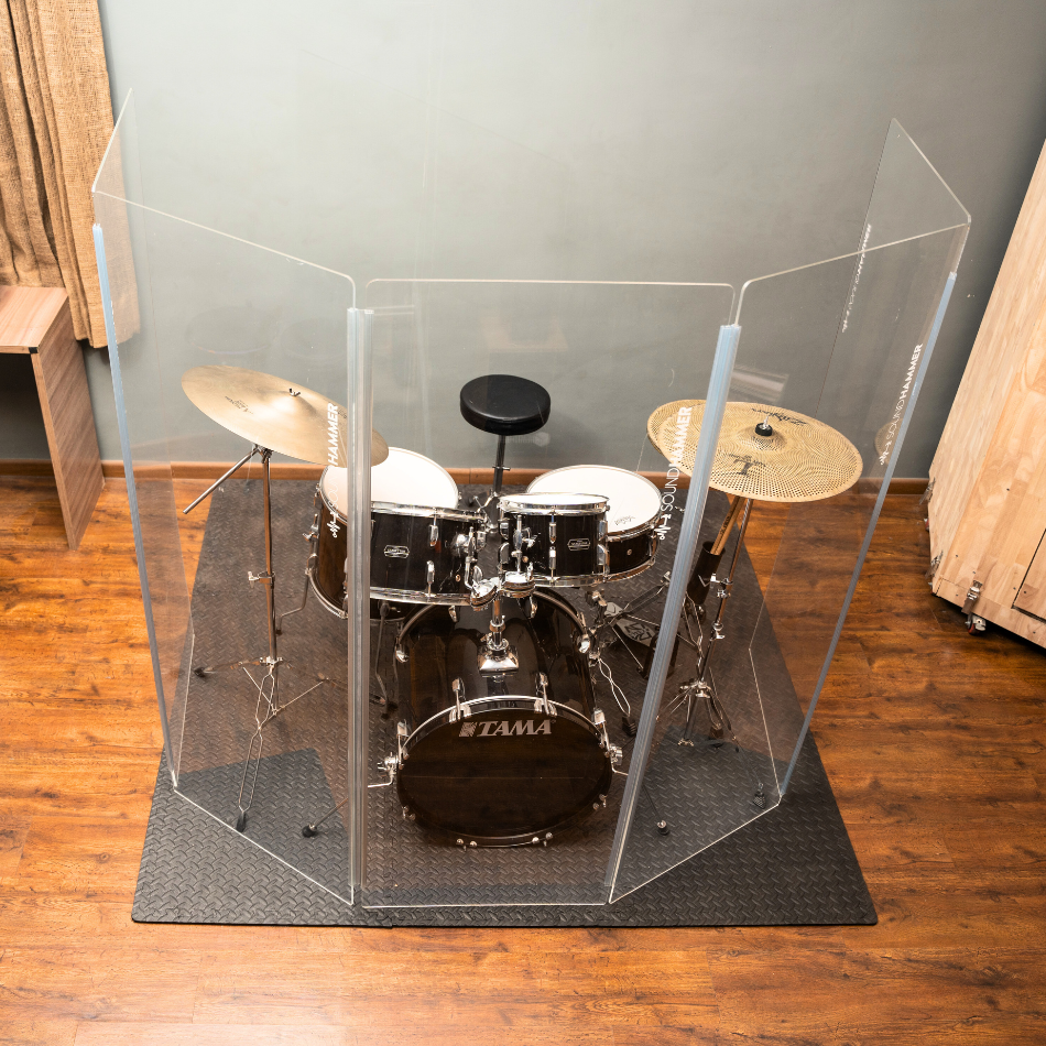 A top view of acryclic drum shield in front of Tama drum kit with clear sound seal hinges by soundhammer.