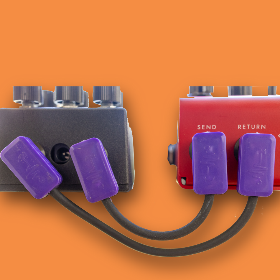 Two audio patch cables with purple connectors on an orange background