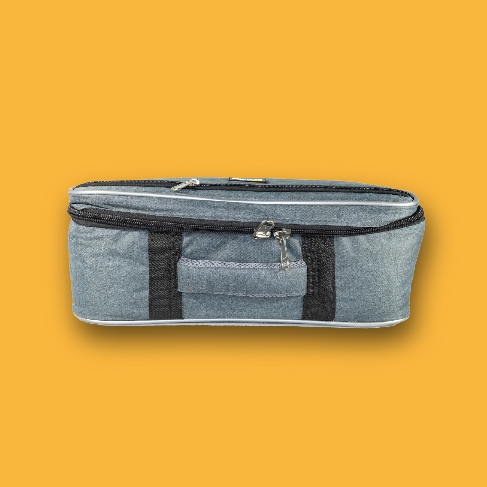 Gray pedalboard gig bag with black straps on a orange background