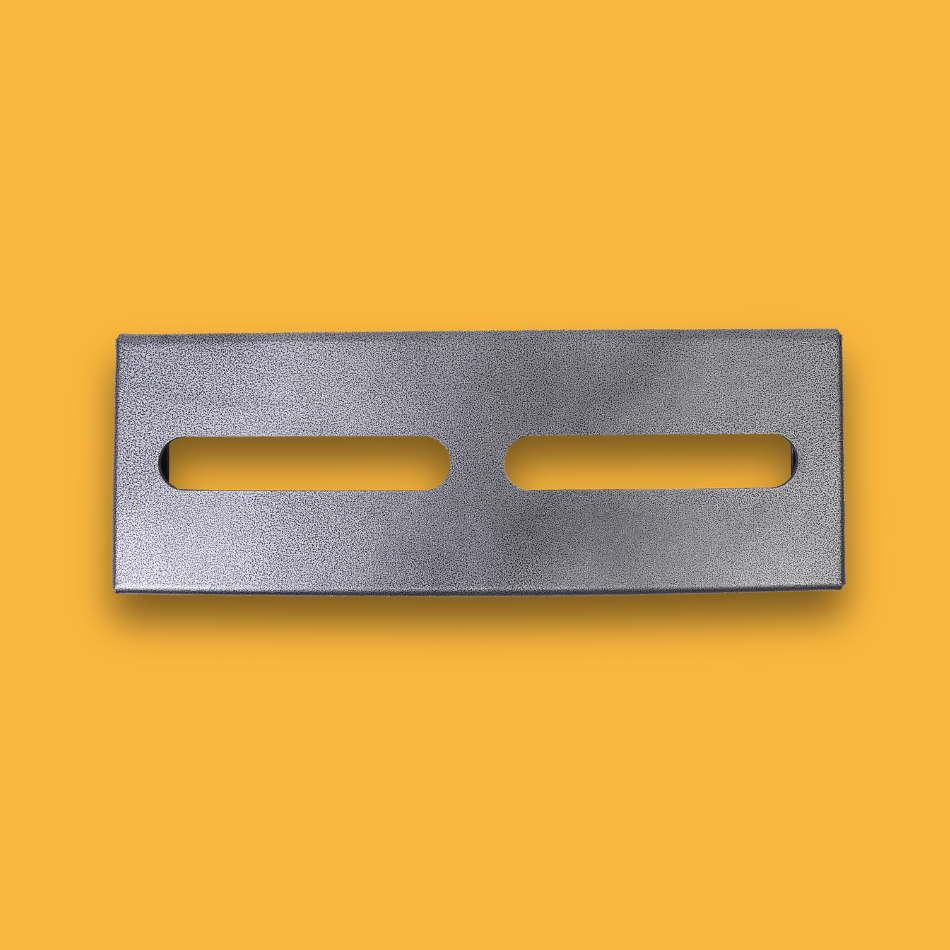 A top view of a grey guitar effects pedalboard made of single sheet of aluminium with two long holes for cable management.