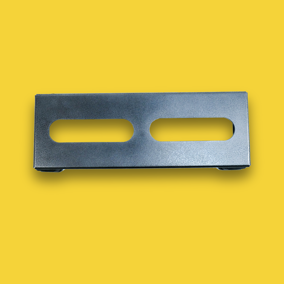 A top view of a grey guitar effects pedalboard made of single sheet of aluminium with two long holes for cable management & 4 legs.