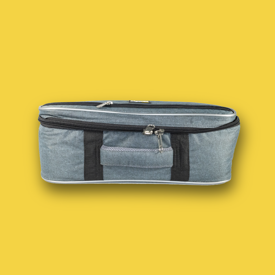 Gray pedalboard gig bag with black straps on a yellow background