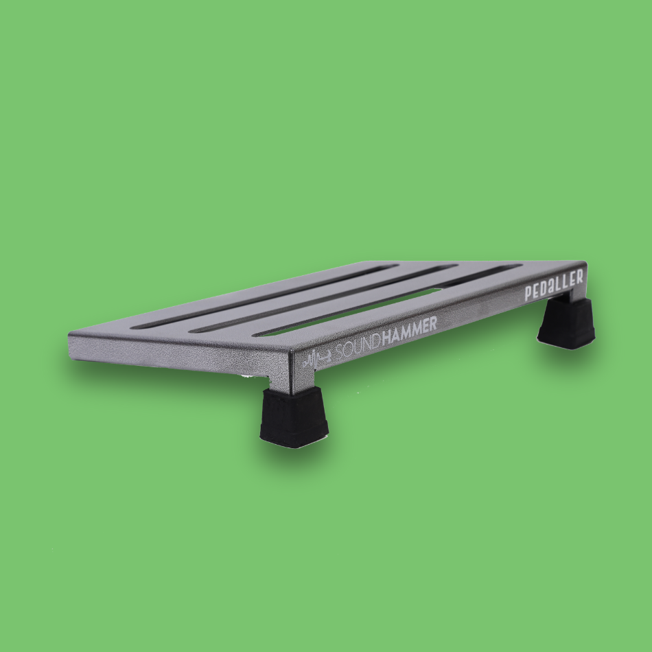 A top angled view of an incline grey guitar effects pedalboard made of single sheet of aluminium with 2 legs and rubber bushings with Soundhammer logo.