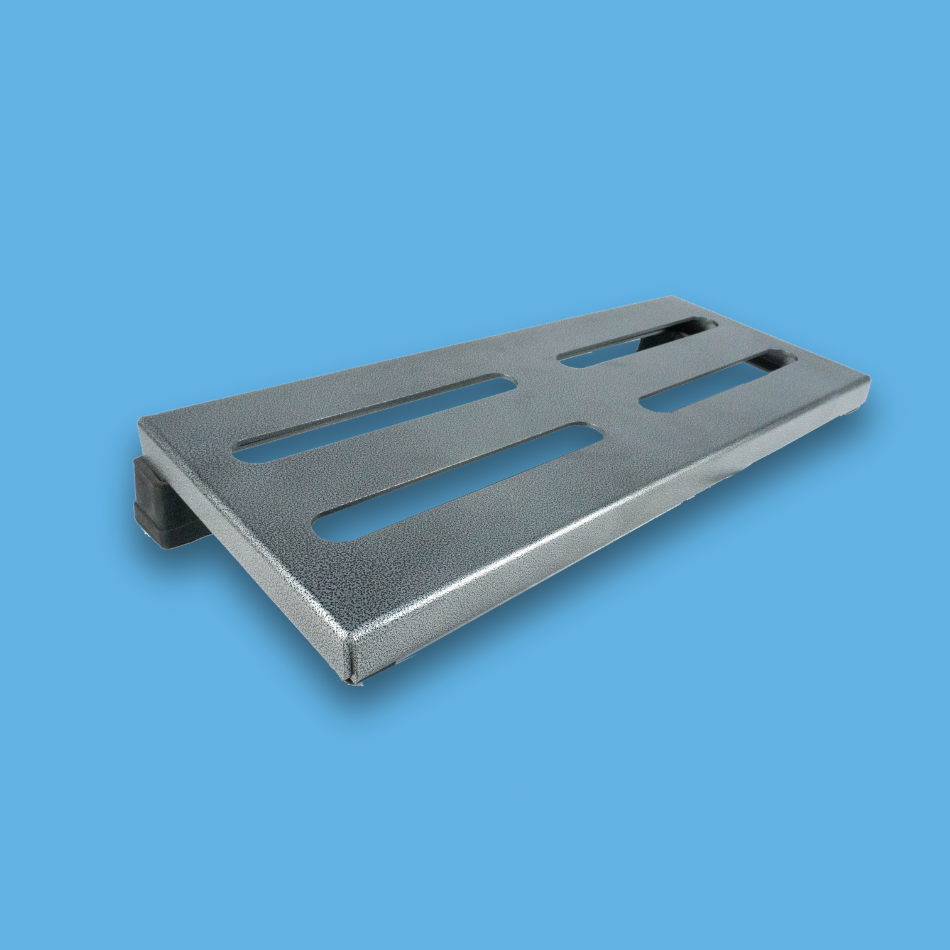 An angled view of a long incline grey guitar effects pedalboard made of single sheet of aluminium with 2 legs and rubber bushings.