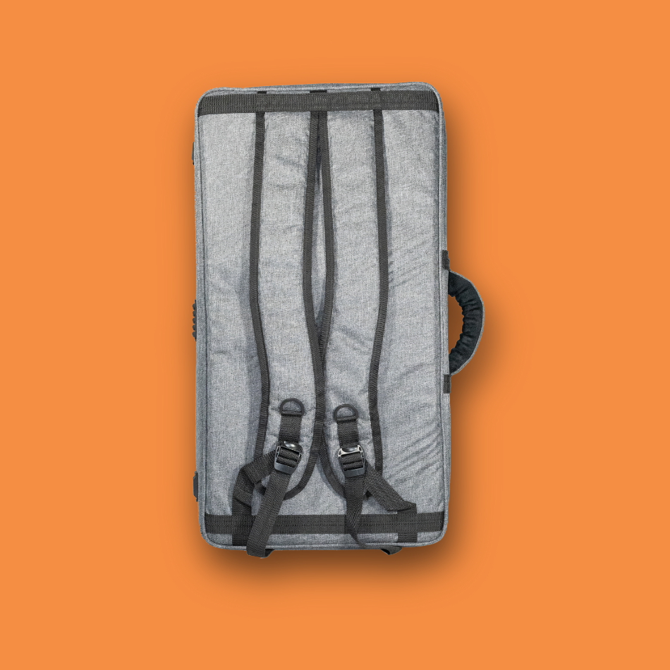Gray Pedalboard gig Bag with black straps on a dark orange background