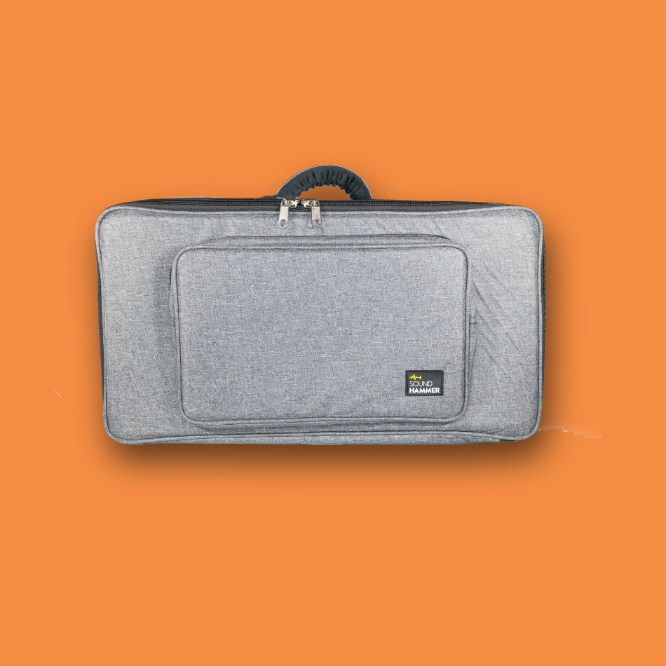 Gray pedalboard gig bag with a brand logo on an dark orange background
