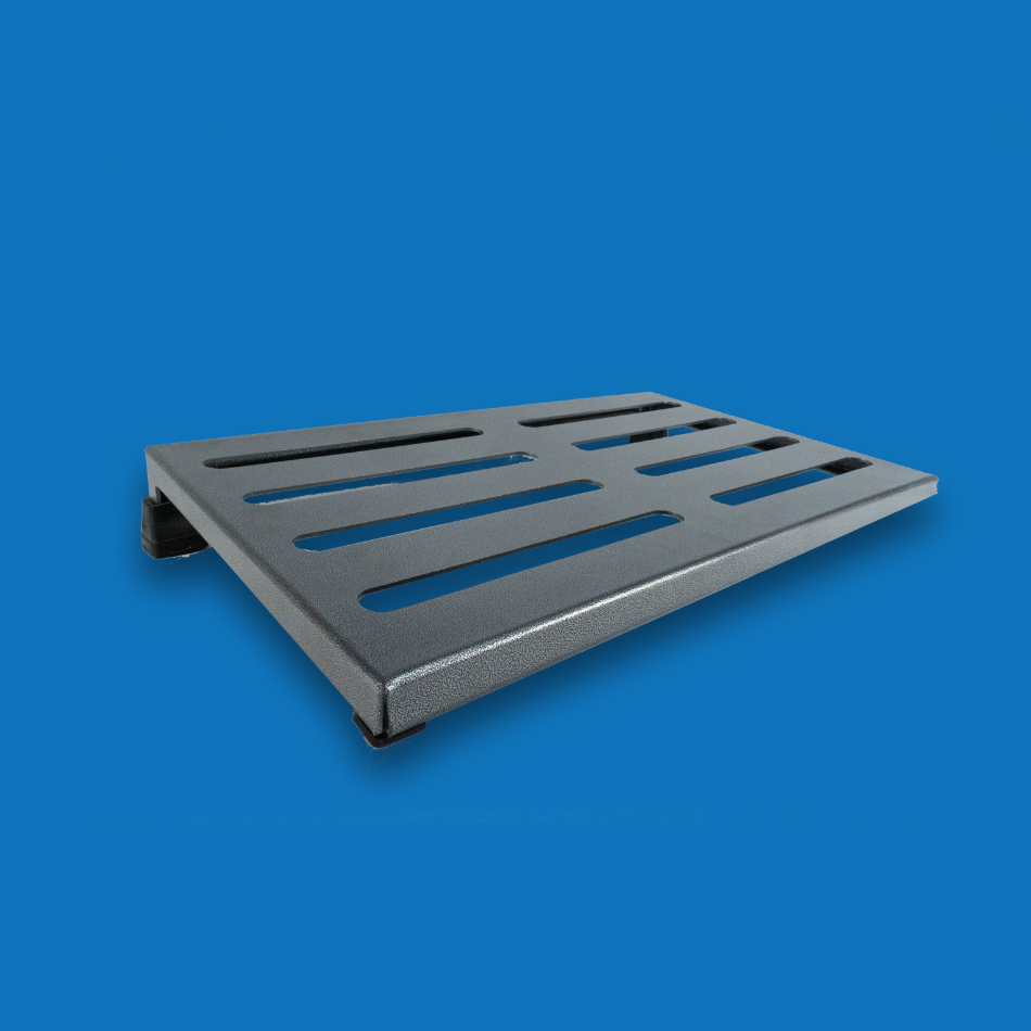 An angled view of a large incline grey guitar effects pedalboard made of single sheet of aluminium with 2 legs and rubber bushings.