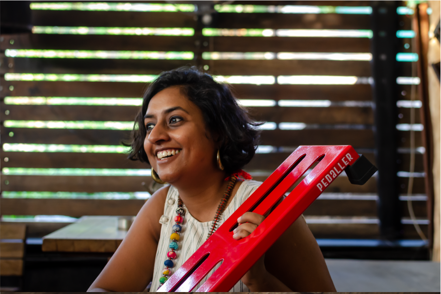 Soundhammer founder Shilpa with a red guitar pedalboard